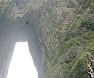   مصر اليوم - مغامر يقفز من هليكوبتر ويمر من شق جبلي ضيق بدون مظلة